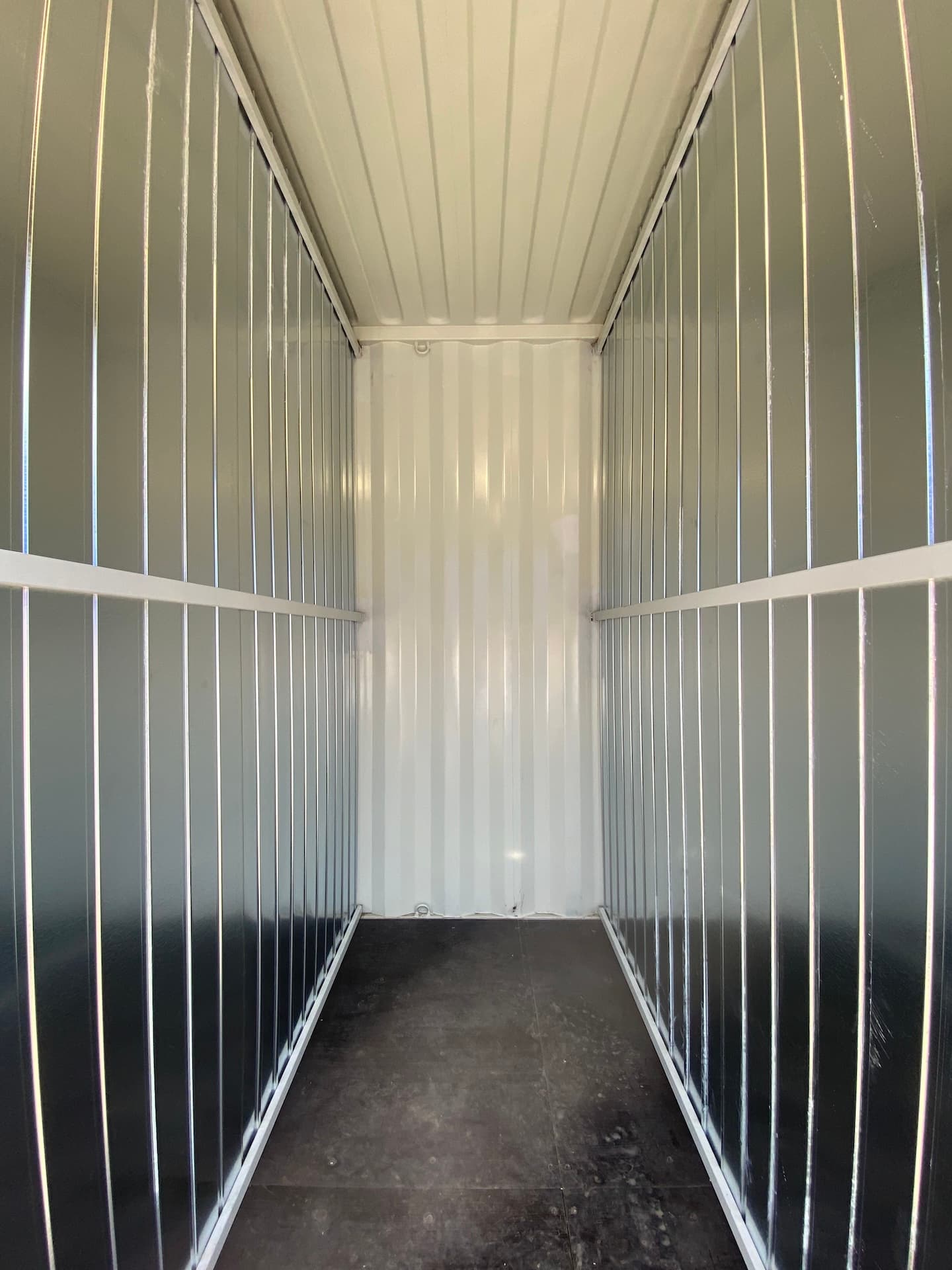 shelving with labeled archive boxes inside container